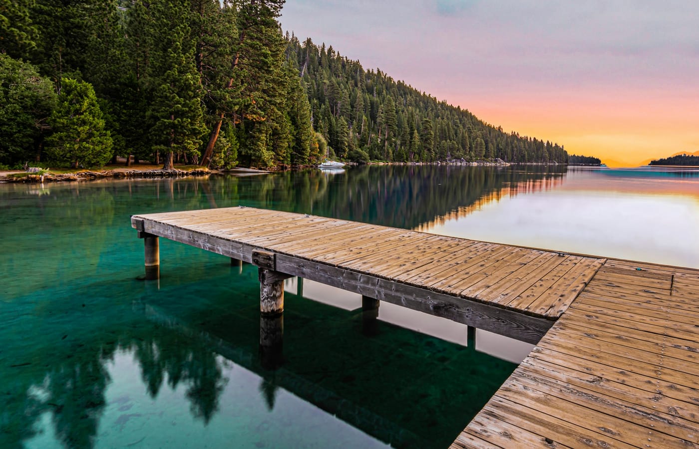 A wooden pier reaching into Lake Tahoe at sunset